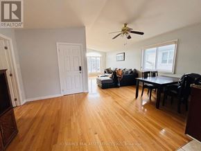 Niagara Falls (Forestview) apartment for rent - A living room with a couch, chairs, and a dining table.