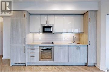 Toronto (Church-Yonge Corridor) condo for rent - A modern kitchen with a sink, stove, and microwave.