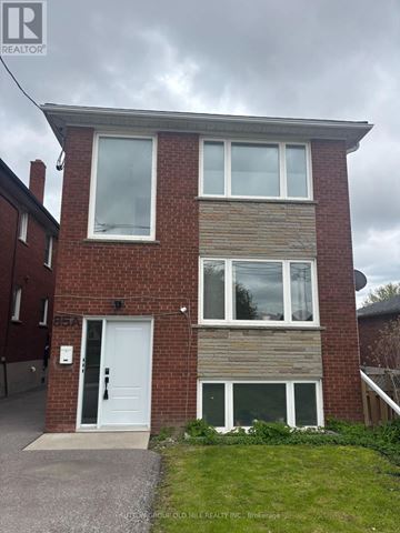 Toronto (Mimico) apartment for rent - A two-story brick house with a white door and windows.