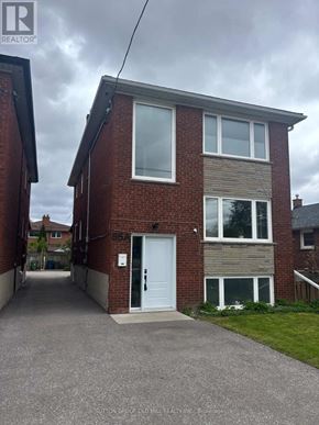 Toronto (Mimico) apartment for rent - A two-story brick house with a white door and windows.