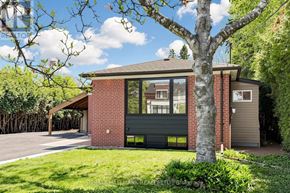 Aurora (Aurora Highlands) apartment for rent - A house with a red brick exterior and a large tree in front.