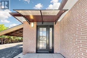 Aurora (Aurora Highlands) apartment for rent - A modern house entrance with a glass door and a brick wall.