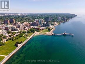 Burlington (Brant) condo for rent - A cityscape with a body of water and a pier.