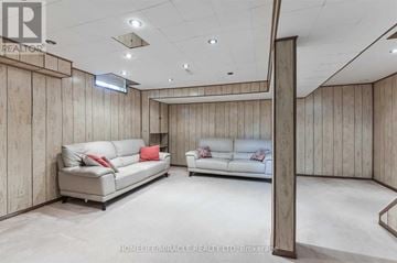 Ajax (South West) apartment for rent - A living room with two couches and a wooden wall.