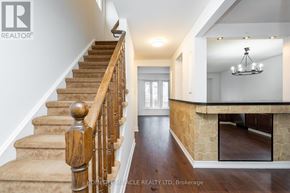 Ajax (South West) apartment for rent - A staircase with wooden balusters and beige carpeted steps leads to a brightly lit open space.