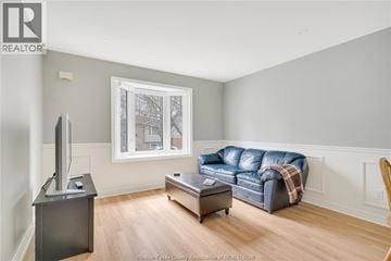 Lasalle apartment for rent - A living room with a blue couch and a television.