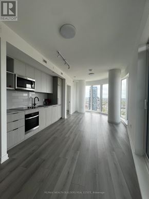 Toronto (Dovercourt-Wallace Emerson-Junction) condo for rent - A modern kitchen with wooden floors and white walls.