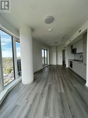 Toronto (Dovercourt-Wallace Emerson-Junction) condo for rent - A spacious room with a large window overlooking a cityscape.
