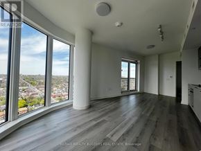 Toronto (Dovercourt-Wallace Emerson-Junction) condo for rent - A spacious room with a view of the cityscape outside the large windows.