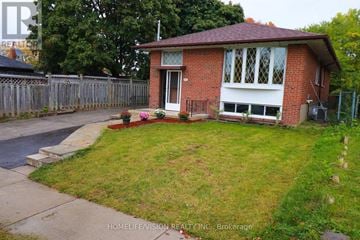 Toronto (Dorset Park) apartment for rent - A red brick house with a white door and windows.