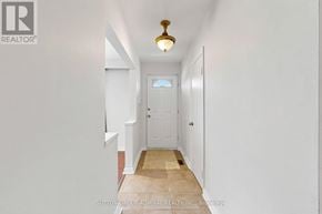 Toronto (Newtonbrook West) apartment for rent - A hallway with a door at the end and a light fixture hanging from the ceiling.
