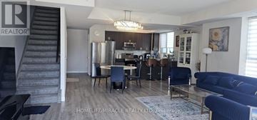 Toronto (Birchcliffe-Cliffside) condo for rent - A living room with a dining table and chairs, and a sofa.
