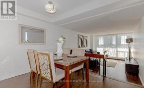Toronto (Agincourt South-Malvern West) condo for rent - A dining room with a table set for two and a view of the balcony.