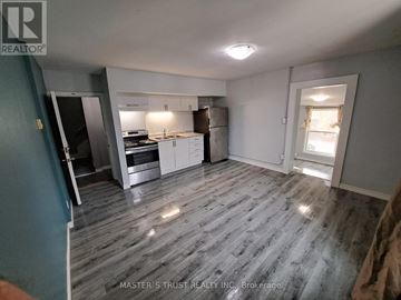 Orillia apartment for rent - A kitchen with a refrigerator, oven, and sink is shown in a real estate listing.