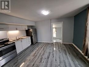 Orillia apartment for rent - A kitchen with a refrigerator, stove, and sink.