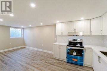 Mississauga (Meadowvale) apartment for rent - A kitchen with a blue oven and white cabinets.