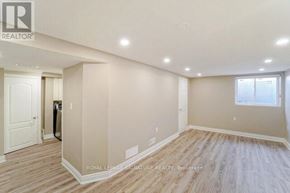 Mississauga (Meadowvale) apartment for rent - A spacious room with wooden flooring and a window with blinds.