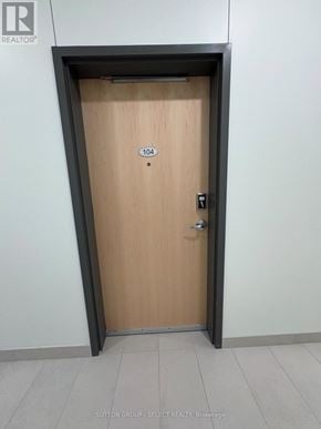 London East (East K) condo for rent - A wooden door with a number 104 on it.