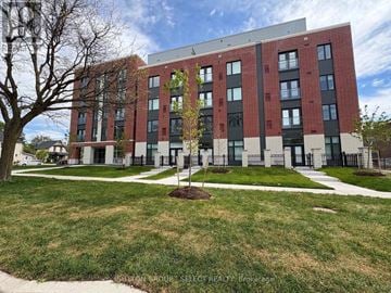 London East (East K) condo for rent - A modern red brick building with a tree in front.