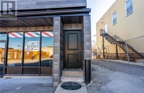 Lincoln (Beamsville) apartment for rent - The image shows a building with a sign that reads "ONY'S STORE" and a staircase leading to a second floor.