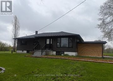Frontenac (Frontenac Centre) apartment for rent - A house with a grey roof and a wooden garage door is shown.