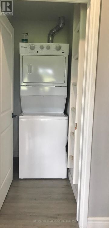 Frontenac (Frontenac Centre) apartment for rent - A white dishwasher is installed in a narrow kitchen space.
