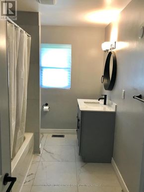 Frontenac (Frontenac Centre) apartment for rent - A bathroom with a sink, mirror, and bathtub.