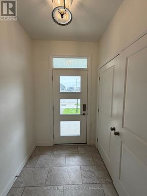 Loyalist (Amherstview) apartment for rent - A hallway with a white door and a light on the ceiling.