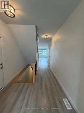 Loyalist (Amherstview) apartment for rent - A long hallway with wood flooring and white walls.
