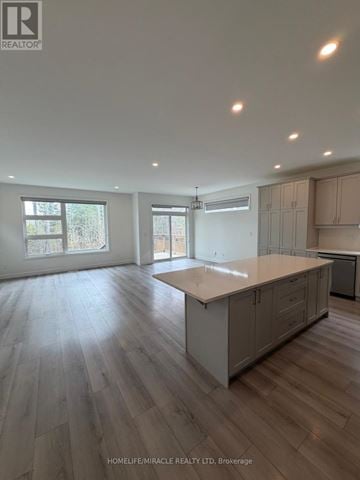 Loyalist (Amherstview) apartment for rent - A spacious kitchen with wooden flooring and white walls.