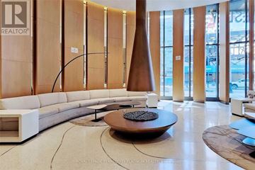 Toronto (Bay Street Corridor) condo for rent - A modern living room with a white sofa and a coffee table.