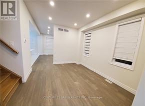 London South (South U) apartment for rent - A well-lit room with wooden flooring and a window with blinds.
