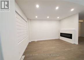 London South (South U) apartment for rent - A spacious room with a fireplace and wooden flooring.