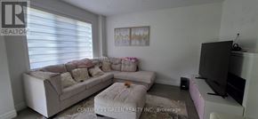 London South (South U) apartment for rent - A living room with a couch, ottoman, and television.