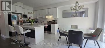 London South (South U) apartment for rent - A modern kitchen with white cabinets and a glass table.