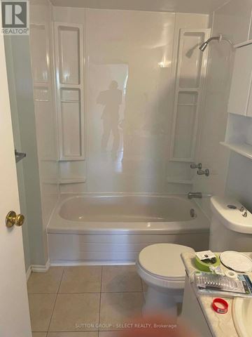 London North (North G) condo for rent - A white bathroom with a toilet, tub, and sink.