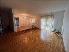 Winnipeg apartment for rent - A room with wooden flooring and a green chair.