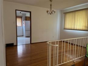 Winnipeg apartment for rent - A room with a white railing and a chandelier.