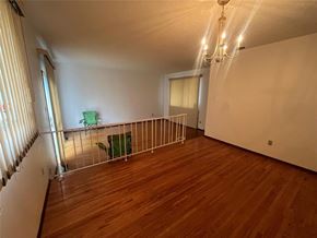 Winnipeg apartment for rent - A room with wooden floors and a green chair.