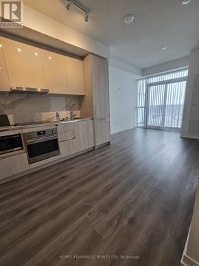 Vaughan (Vaughan Corporate Centre) condo for rent - A spacious kitchen with wooden floors and modern appliances.