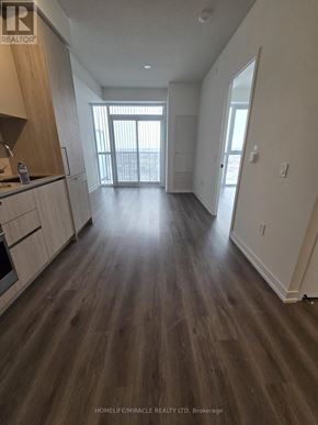 Vaughan (Vaughan Corporate Centre) condo for rent - A spacious kitchen with wooden floors and white walls.