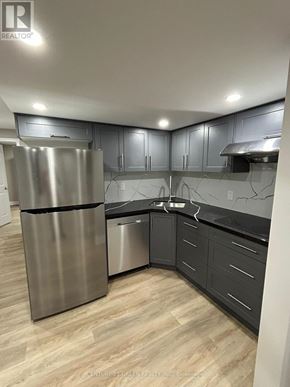 Oshawa (Kedron) apartment for rent - A kitchen with a stainless steel refrigerator and a marble backsplash.