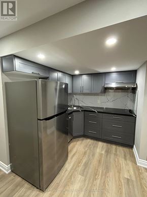 Oshawa (Kedron) apartment for rent - A kitchen with a stainless steel refrigerator and wooden floors.