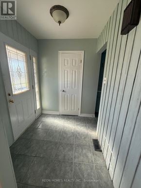 Toronto (Highland Creek) apartment for rent - A hallway with a white door and a window with a stained glass design.