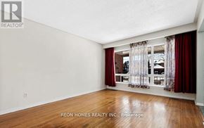 Toronto (Highland Creek) apartment for rent - A room with a window and curtains, with a sign that says REON HOMES REALTY INC. Brokerage.