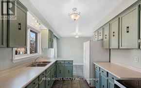 Toronto (Highland Creek) apartment for rent - A kitchen with green cabinets and a white refrigerator.