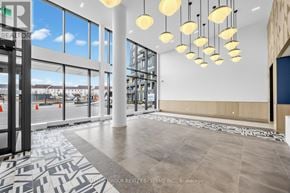 Burlington (Alton) condo for rent - A modern office lobby with a black and white tiled floor.