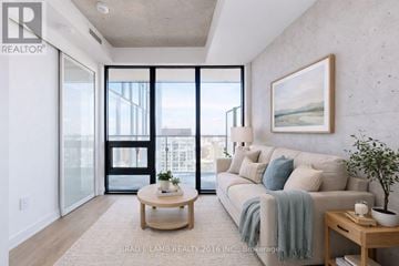 Toronto (Moss Park) condo for rent - A living room with a couch, coffee table, and a painting on the wall.