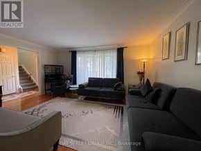 Markham (Bullock) apartment for rent - A living room with a couch, chair, and lamp.