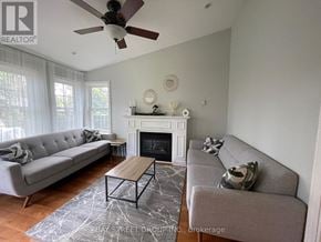 Markham (Bullock) apartment for rent - A living room with a grey couch, a fireplace, and a ceiling fan.